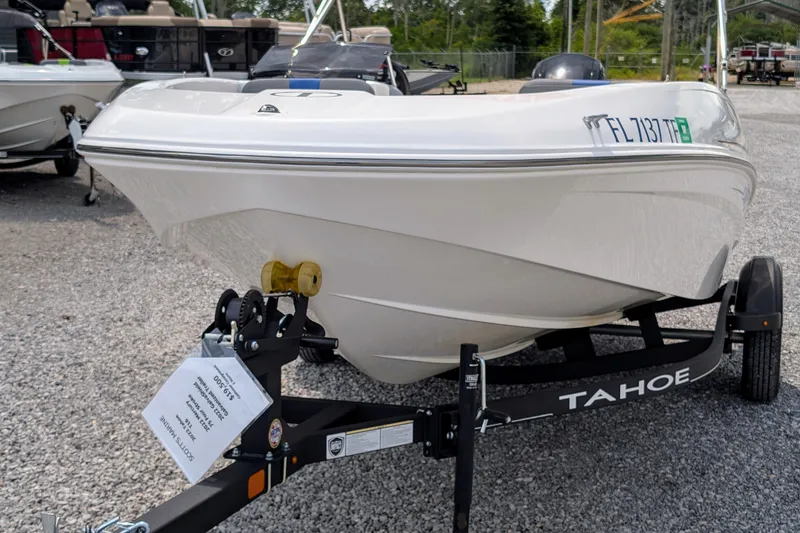 Slide: The Image of 2022 Tahoe T16 boat on trailer, parked on gravel lot. - 7