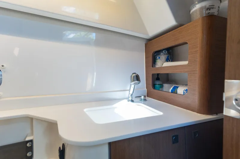 Slide: The Image of Modern bathroom interior of 2021 Beneteau Antares 9 yacht with sink and storage shelves. - 10