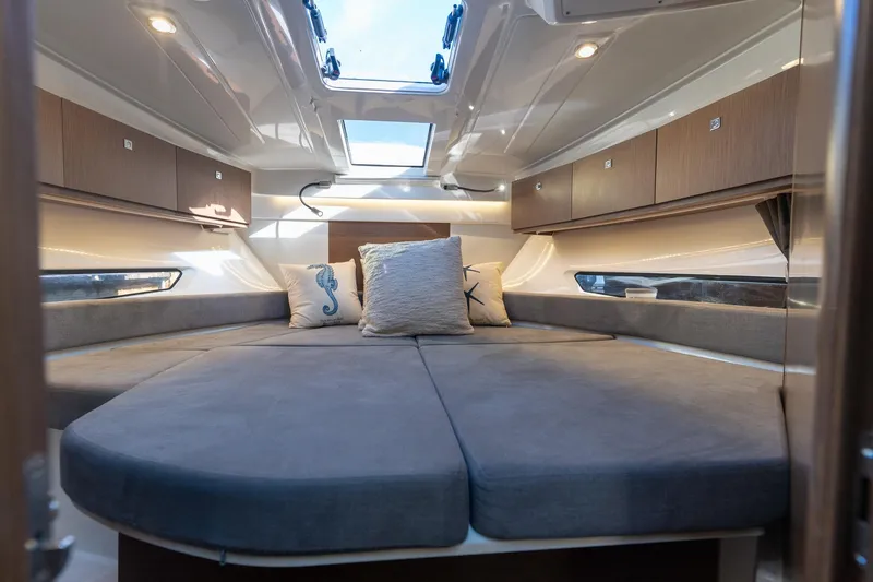 Slide: The Image of Luxurious interior of 2021 Beneteau Antares 9 boat with cozy bedding and skylight. - 12