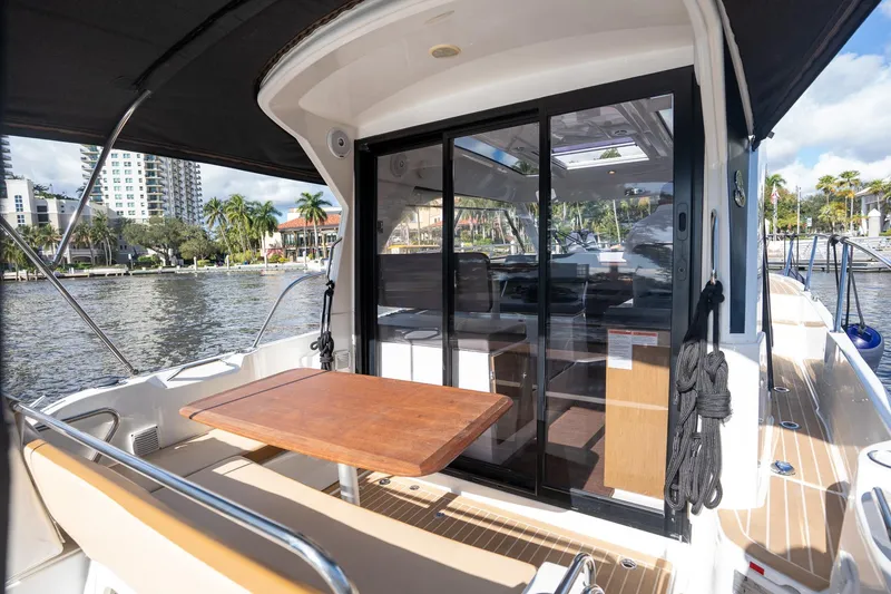 Slide: The Image of 2021 Beneteau Antares 9 boat with outdoor seating and sliding glass doors. - 19