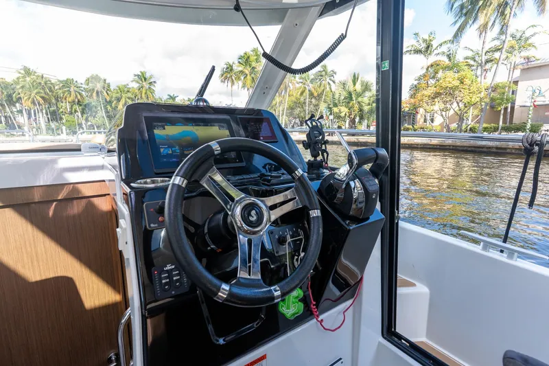 Slide: The Image of Cockpit of 2021 Beneteau Antares 9 boat with steering wheel and navigation system. - 23