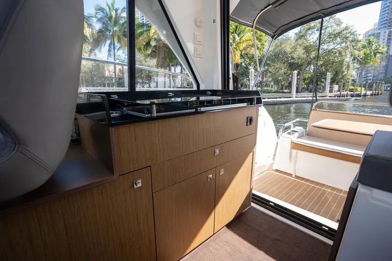 Slide: The Image of Interior view of 2021 Beneteau Antares 9 boat with kitchenette and outdoor seating. - 28