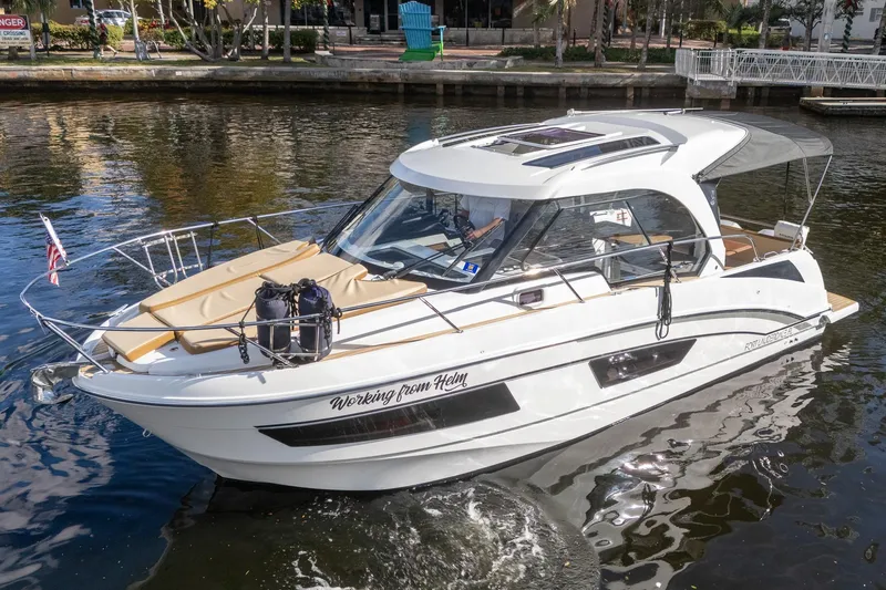 Slide: The Image of 2021 Beneteau Antares 9 boat cruising on a calm waterway, featuring sleek design and modern amenities. - 3