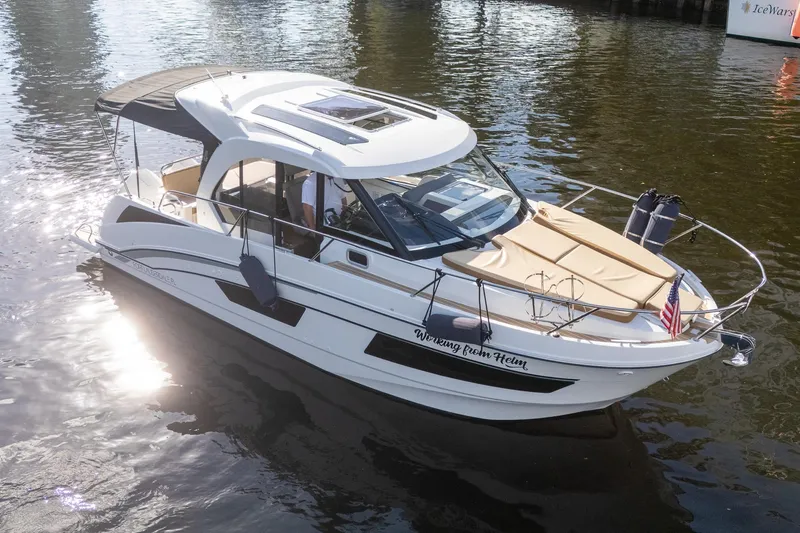Slide: The Image of 2021 Beneteau Antares 9 boat on water, featuring sleek design and sunlit deck. - 5
