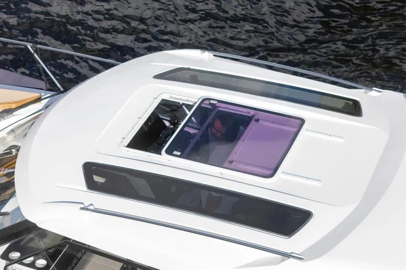 Slide: The Image of 2021 Beneteau Antares 9 boat roof with open hatch, on water. - 9