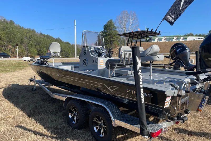 The Image of 2024 Express H22 boat on trailer, featuring sleek design and modern equipment, parked outdoors. - 2