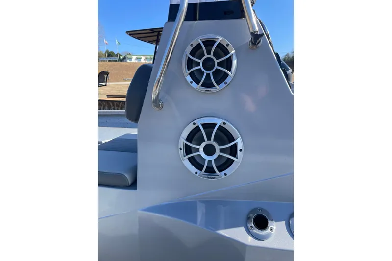 Slide: The Image of 2024 Express H22 boat with dual marine speakers and stainless steel railing. - 8