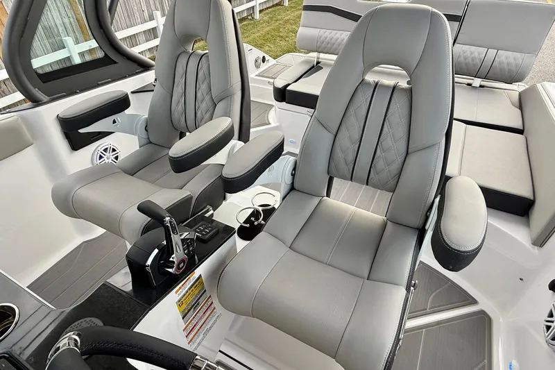 Slide: The Image of 2026 Monterey Elite 25 OB boat interior with luxurious gray seating and modern controls. - 10