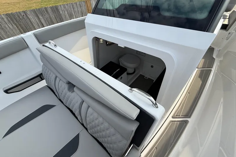 Slide: The Image of 2026 Monterey Elite 25 OB boat interior with open storage compartment and seating. - 18