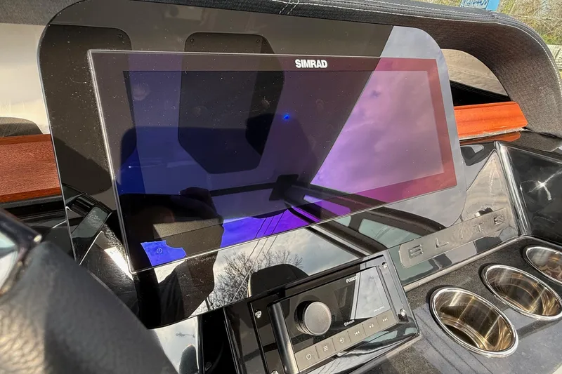 Slide: The Image of Dashboard of 2026 Monterey Elite 25 OB boat with Simrad display and controls. - 19
