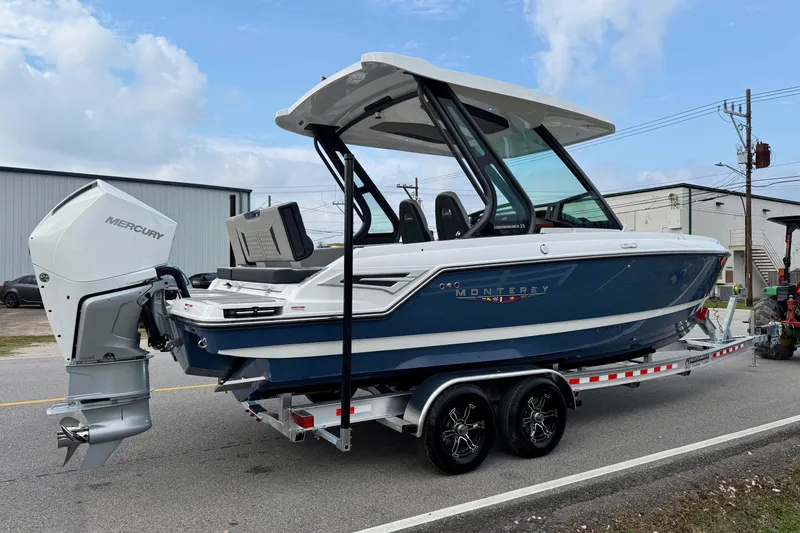 Slide: The Image of 2026 Monterey Elite 25 OB boat on trailer with Mercury outboard motor. - 4