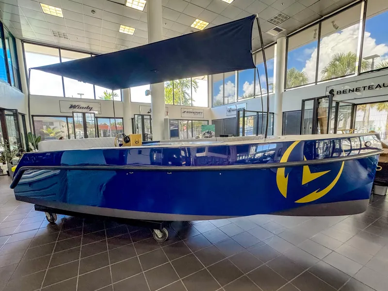 Slide: The Image of 2025 Vision Marine Technologies Volt 180 electric boat displayed indoors. - 1