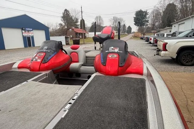 Slide: The Image of 2008 Ranger Z20 Comanche boat with red and black seats, parked outdoors. - 8