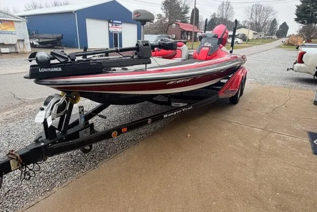 Slide: The Image of 2008 Ranger Z20 Comanche boat on trailer, red and black, parked on driveway. - 9