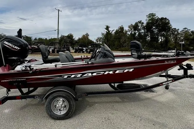 Slide: The Image of 2022 Tracker Pro Team 175 TXW boat on trailer, side view, outdoors. - 2