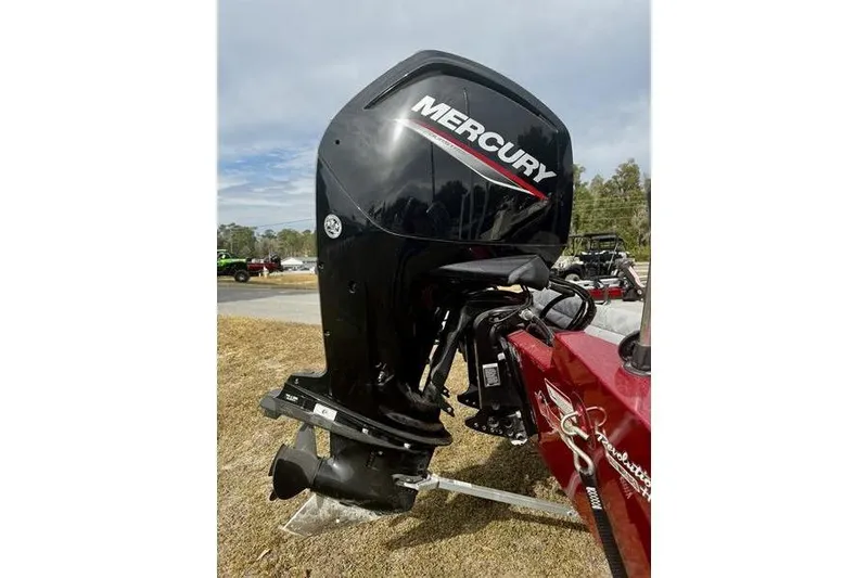Slide: The Image of 2022 Tracker Pro Team 175 TXW with Mercury outboard motor, parked outdoors. - 4
