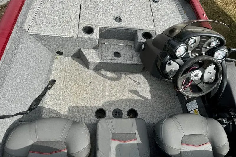 Slide: The Image of 2022 Tracker Pro Team 175 TXW boat interior with steering console and seating. - 7