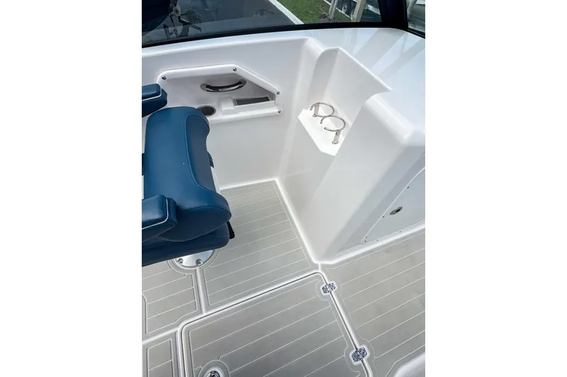 Slide: The Image of 2024 Aquasport AS DC 22 boat interior with blue seating and cup holders. - 15