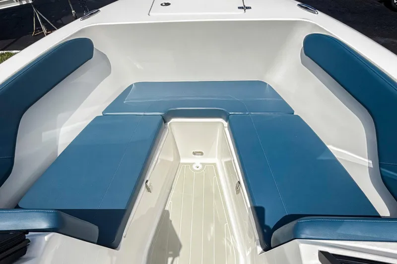 Slide: The Image of 2024 Aquasport AS DC 22 boat interior with blue cushioned seating. - 25