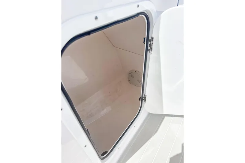 Slide: The Image of Open storage compartment on 2024 Aquasport AS DC 22 boat, showcasing interior space. - 17