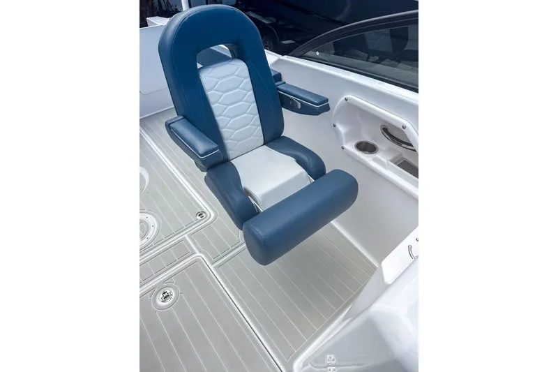 Slide: The Image of 2024 Aquasport AS DC 22 boat seat with blue and white upholstery, cup holder nearby. - 14