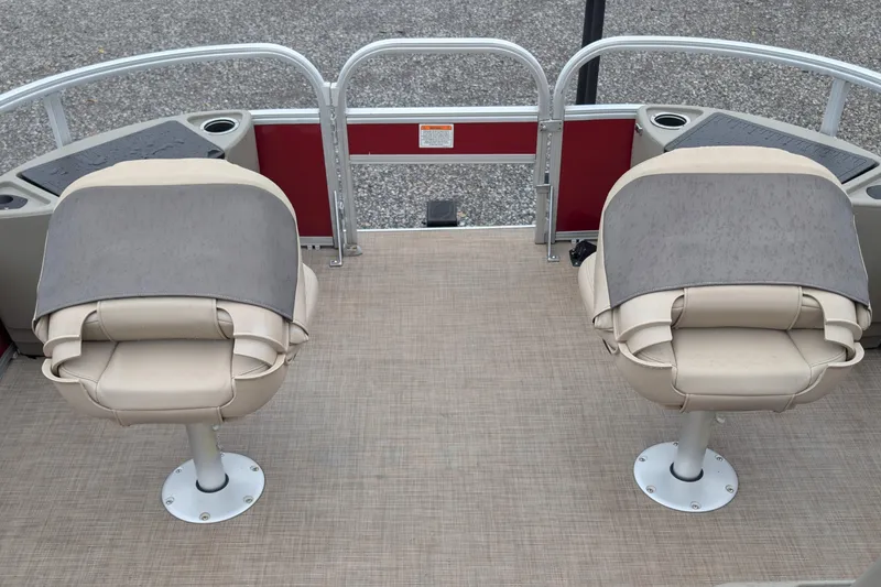Slide: The Image of 2023 Sun Tracker Party Barge 18 with beige seats and red accents on deck. - 5