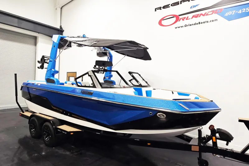 The Image of 2026 Nautique Super Air Nautique GS20 boat in showroom, blue and black design. - 1