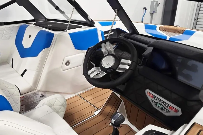 Slide: The Image of 2026 Nautique Super Air Nautique GS20 interior with blue and white seating, modern dashboard. - 10