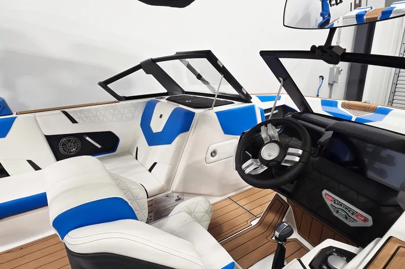 Slide: The Image of 2026 Nautique Super Air Nautique GS20 interior with blue and white seating, modern dashboard. - 7
