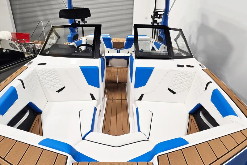 Slide: The Image of 2026 Nautique Super Air Nautique GS20 interior with blue and white seating, wood accents. - 8