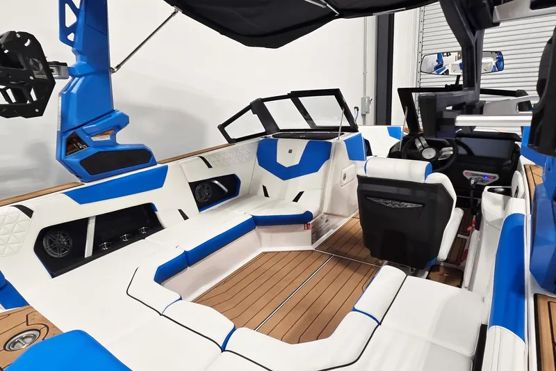 Slide: The Image of 2026 Nautique Super Air Nautique GS20 interior with blue and white seating, modern dashboard. - 9