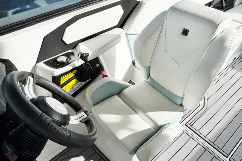 Slide: The Image of 2023 Nautique Super Air Nautique S25 cockpit with steering wheel and control panel. - 11