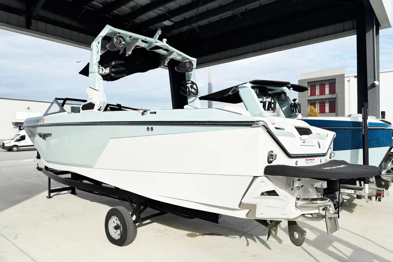 Slide: The Image of 2023 Nautique Super Air Nautique S25 boat on trailer under shelter. - 3