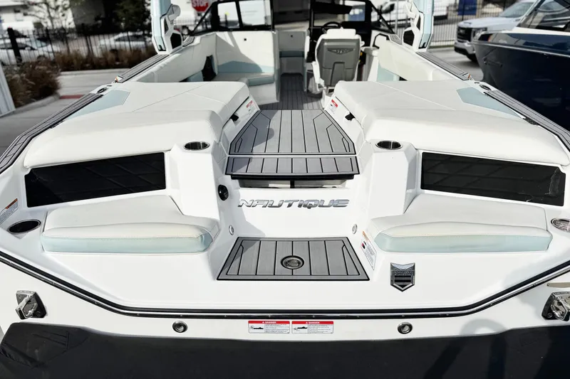 Slide: The Image of 2023 Nautique Super Air Nautique S25 boat interior with seating and deck view. - 4