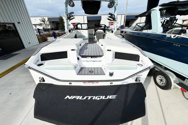 Slide: The Image of 2023 Nautique Super Air Nautique S25 boat displayed outdoors, showcasing sleek design and spacious interior. - 5