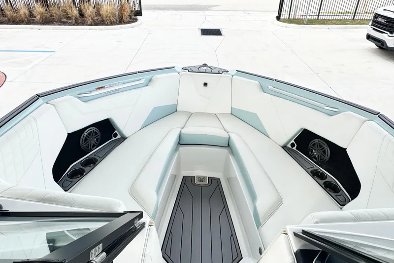 Slide: The Image of 2023 Nautique Super Air Nautique S25 boat interior with white and light blue seating. - 7