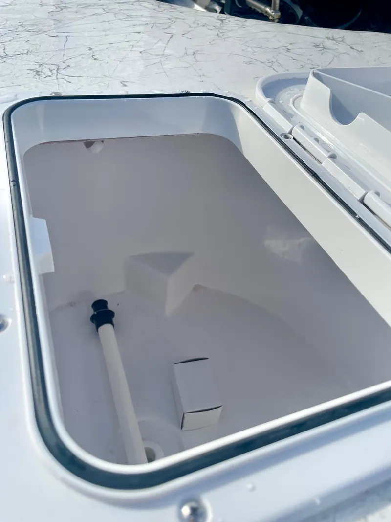 Slide: The Image of 2025 Coastal Skiff 212 boat storage compartment with open hatch. - 5