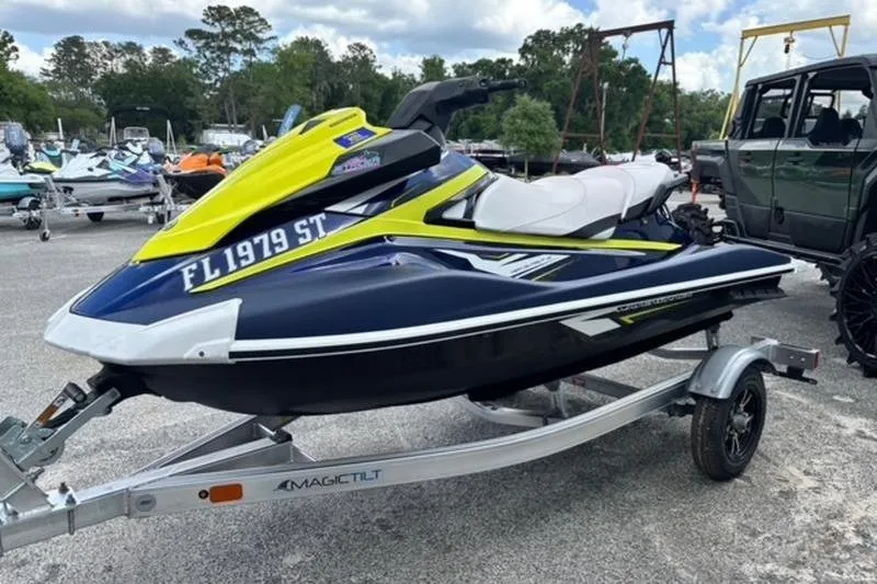 Slide: The Image of 2020 Yamaha WaveRunner VX Deluxe on trailer, vibrant yellow and blue design, parked outdoors. - 3