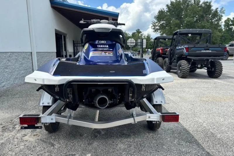 Slide: The Image of 2020 Yamaha WaveRunner VX Deluxe on trailer, parked outdoors near utility vehicles. - 6