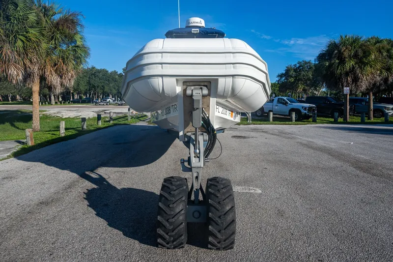 Slide: The Image of 2023 Ocean Craft 38 boat on amphibious wheels in a sunny parking area. - 11