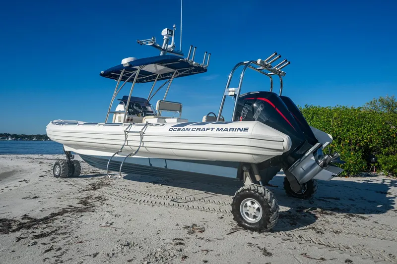 Slide: The Image of 2023 Ocean Craft 38 amphibious boat on sandy beach with clear blue sky. - 14