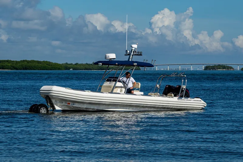 Slide: The Image of 2023 Ocean Craft 38 boat cruising on blue water under a clear sky. - 16