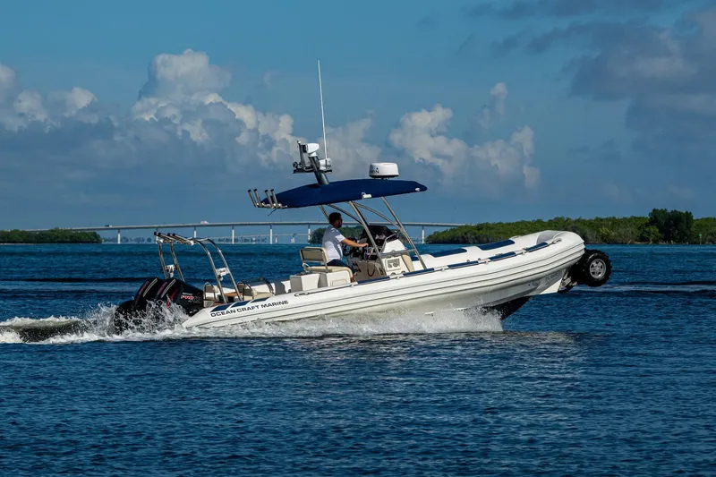Slide: The Image of 2023 Ocean Craft 38 boat cruising on water with clear blue sky background. - 21