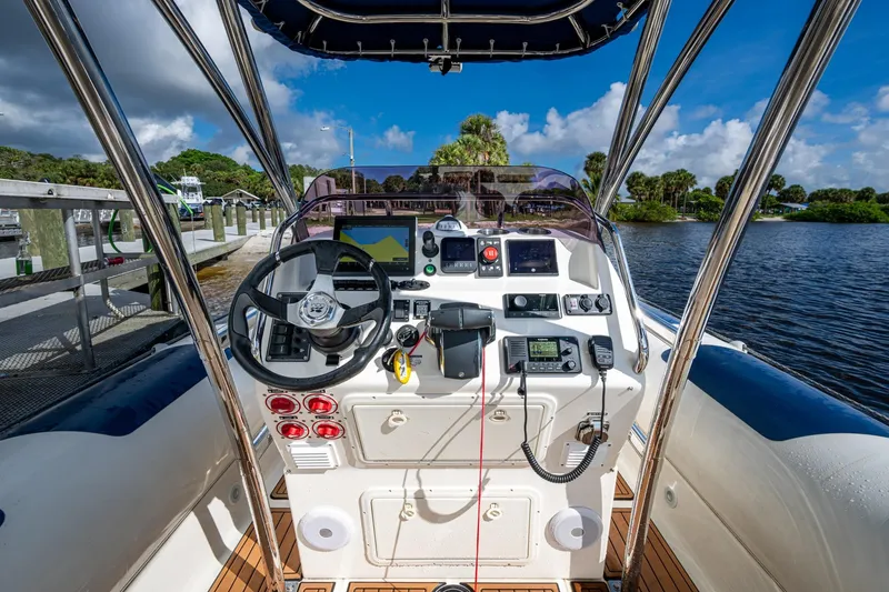 Slide: The Image of Cockpit view of 2023 Ocean Craft 38 boat with navigation equipment and steering wheel. - 6