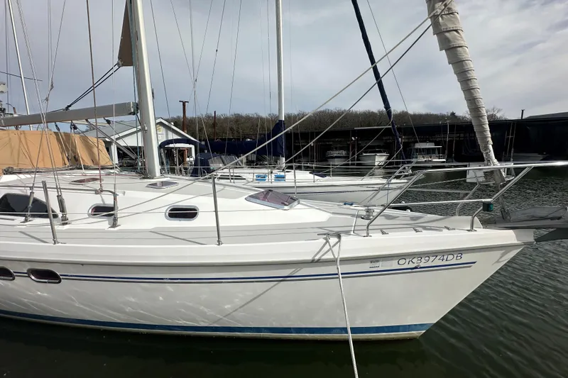 Slide: The Image of 2006 Catalina 387 sailboat docked in marina, side view with sails furled. - 1