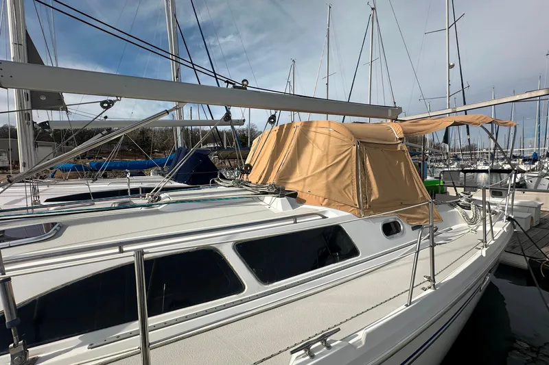 Slide: The Image of 2006 Catalina 387 sailboat docked at marina with tan canopy. - 10