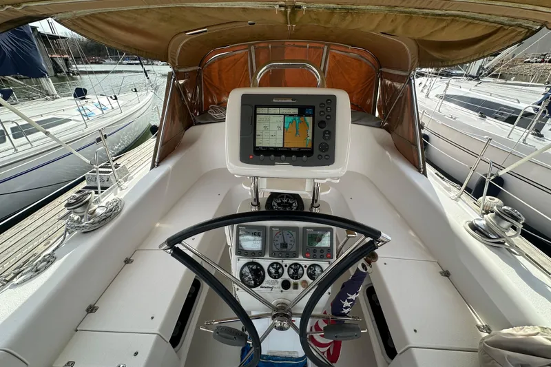 Slide: The Image of Cockpit of 2006 Catalina 387 sailboat with navigation equipment and steering wheel. - 13
