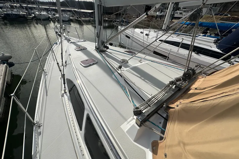 Slide: The Image of 2006 Catalina 387 sailboat docked at marina, showcasing deck and rigging. - 14
