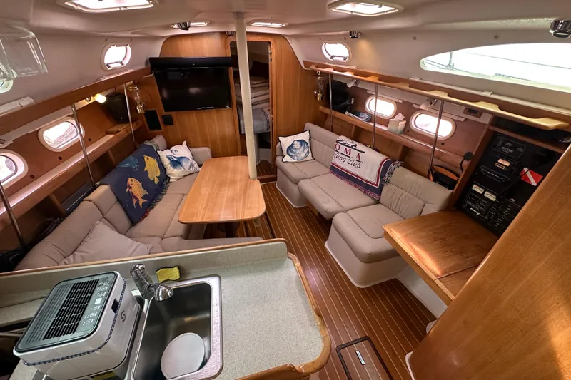 Slide: The Image of Interior of a 2006 Catalina 387 sailboat with cozy seating and wooden finishes. - 21