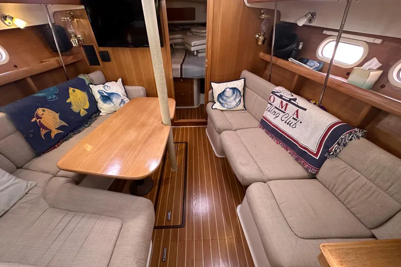 Slide: The Image of Interior of a 2006 Catalina 387 sailboat with cozy seating and nautical decor. - 23
